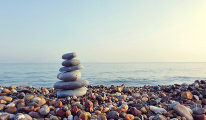 Spa stones balance on the pebble beach.