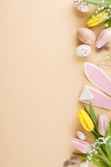 Celebrating Easter with enthusiasm, embracing the joy of renewal. Top view vertical shot of bunnies ears, eggs, flowers, sprinkles, feathers on beige background with promo space