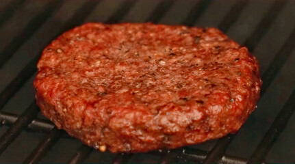 Cooking burger beef patty on a hot grill close up. Preparing burger, homemade. Grocery product advertising, menu.