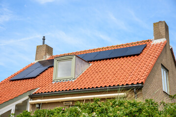 Solar panels for electricity generation on the roof of a modern energy efficient brick house