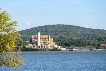 Waste incinerator on the forested bank of a river on a clear autumn day