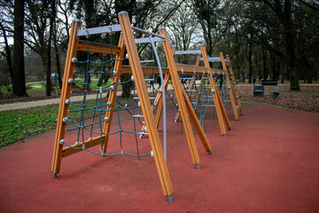 playground in the park, wood made, green trees