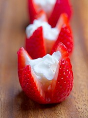 Close up of strawberries and whipped cream.