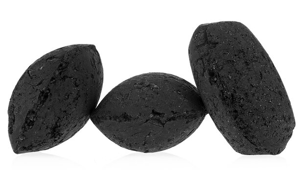 Pressed charcoal or coconut barbecue coal isolated on a white background. Bbq briquettes.