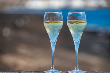 Pouring a glass of champagne on vacation, south of Fuerteventura, Canary islands, blue ocean, mountains