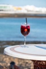 Glass of cold sangria wine served with orange in beach cafe, Corralejo, Fuerteventura, Spain