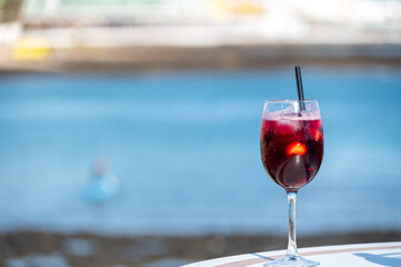 Glass of cold sangria wine served with orange in beach cafe, Corralejo, Fuerteventura, Spain