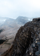 girl on a cliff in the rockies