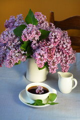 spring still life with a cup of tea and a bouquet of flowers