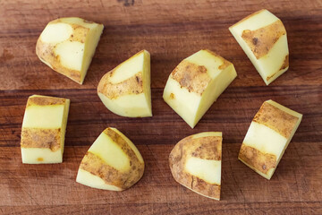 Healthy fresh meal preparation, potato on wooden board. Homemade cooking potato for restaurant, menu, advert or package, close up, selective focus.