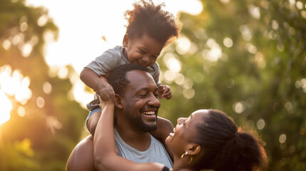 Joyful family moment with a man giving a toddler a piggyback ride, both smiling and playing