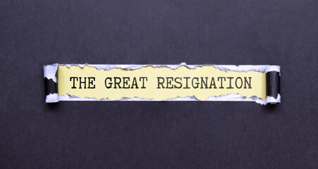 Torn notebook paper on gray copy space background with text THE GREAT RESIGNATION