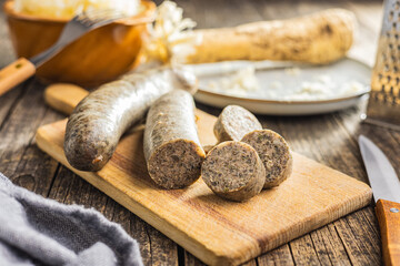 White pudding sausage. Pork product on cutting board on wooden table.