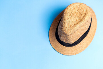 Straw hat on blue background. Studio photo. Bohemian concept. Hat concept.
