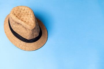 Fototapeta na wymiar Straw hat on blue background. Studio photo. Bohemian concept. Hat concept.