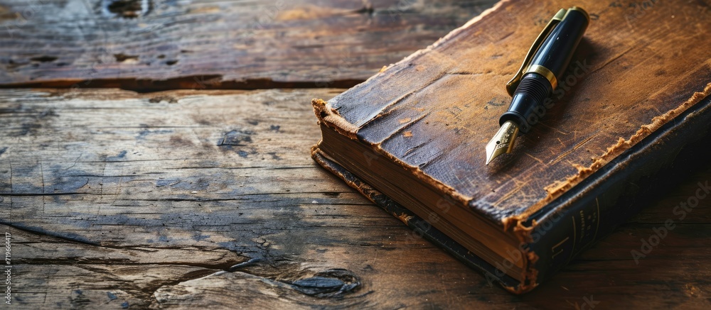 Poster top view of old open book with fountain pen on wooden table. copy space image. place for adding text