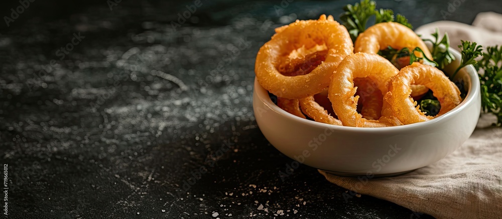 Aufkleber white bowl with onion rings on dark surface top view. copy space image. place for adding text