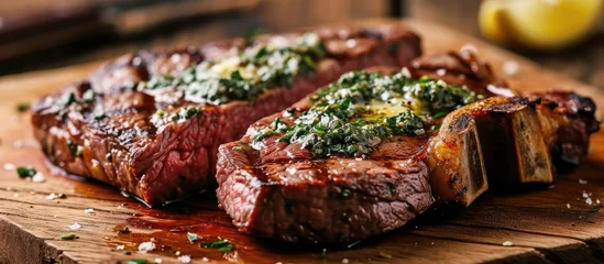  Sliced grilled Medium rare barbecue steak Ribeye with herb butter on cutting board close up. Copy space image. Place for adding text © Ilgun