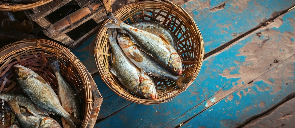 Poster several baskets full of fish freshly caught from the sea. copy space image. place for adding text