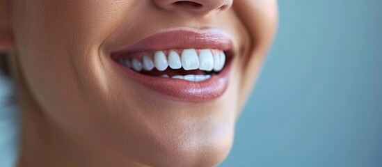 Fototapeta premium Perfect healthy teeth smile of a young woman Teeth whitening Dental clinic patient Image symbolizes oral care dentistry stomatology. Copy space image. Place for adding text