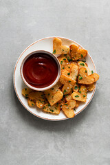 Valentine's Day roasted potato hearts on a white plate on concrete background. Romantic food ideas for Valentine's Day