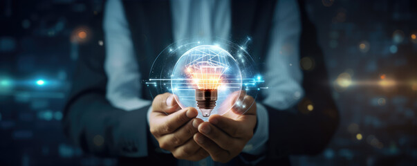 Businessman hands with lightbulb on wide background.