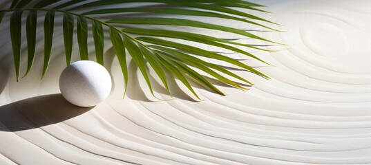 Zen pattern in white sand with palm leaves, beautiful sandy texture for spa and relaxation concept