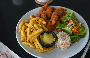 fried chicken and french fries in a cafe by the sea 1