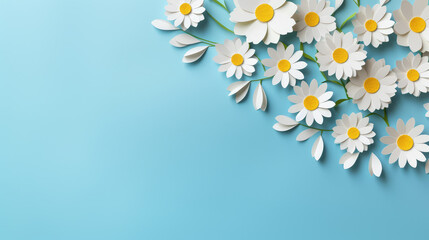 paper flowers on aquamarine blue background with copy space