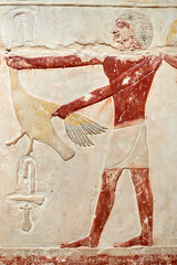 A man carrying a goose for ritual offering, wall painting from the V Dynasty mastaba of princess Idut, Saqqara, Egypt
 - obrazy, fototapety, plakaty