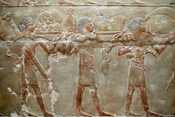 Procession of men carrying food offerings for the deceased owner of a V Dynasty mastaba - Idut....