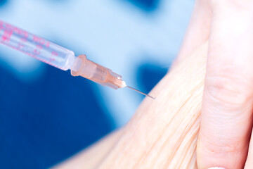Nurse injecting insulin in abdomen of diabetic senior patient. 