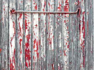 Creepy metal hook. Rustic wooden background with red paint like blood.