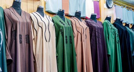 arabic women dress abaya for sale at a textile store in the souq faleh.