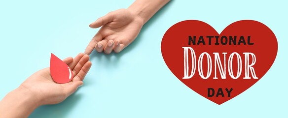 Awareness banner for National Donor Day with hands and paper blood drop