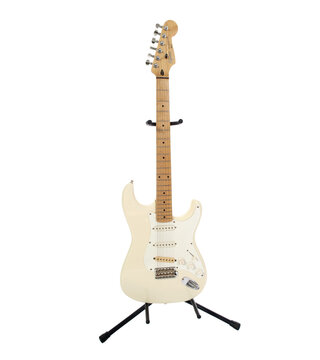 Los Angeles, California, USA - October 24, 2009:  Illustrative editorial photo of white Fender Squier Stratocaster electric guitar on stand.  Isolated with cut out background.