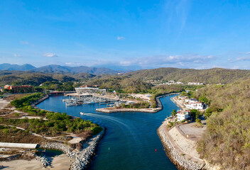 aerial view water body with buildings and hills around it against sky