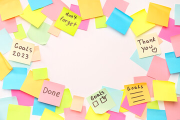 Frame made of sticky notes with words on white background