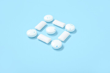 White chewing gums on blue background