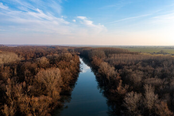 Riverside Reflections: Aerial Snapshot of Danube and Forest Under Sky