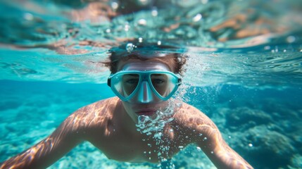 Young man snorkeling in clear tropical turqoise waters
