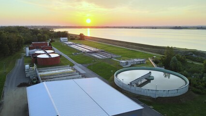 Drinking Water purification Industry system plant in natural environment with green forest and river © TechAnimationStock