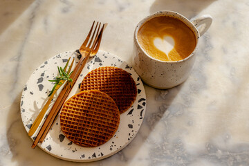 Selective focus of cappuccino, latte art coffee with white milk foam in heart-shaped, Dutch...
