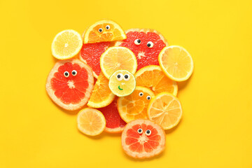 Composition with slices of fresh citruses for lemonade on yellow background