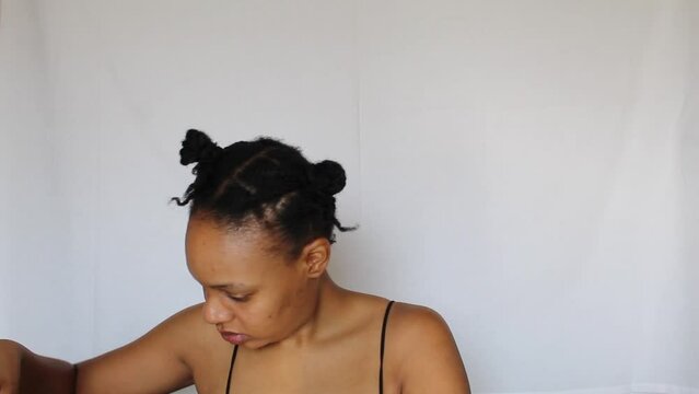 Black woman with two ponytails on her natural 4c hair on a white background