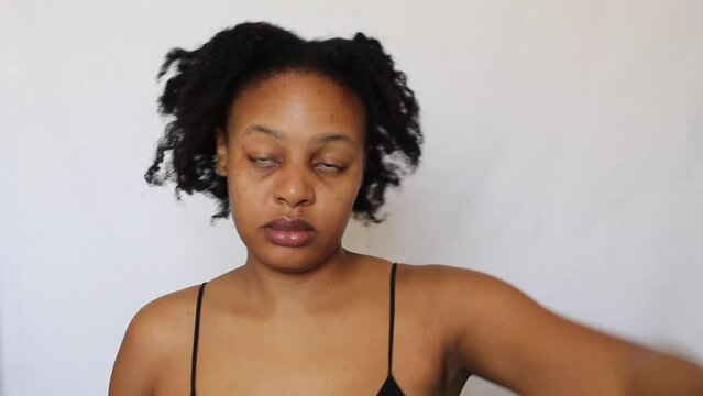 Black woman with her natural 4c hair on a white background