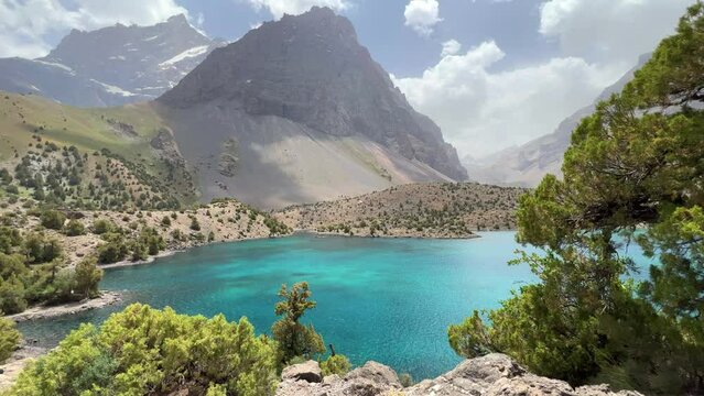 The Alaudin (Chapdara) lakes, lying at an altitude of 2800 m, are considered one of the most beautiful lakes of the Fan Mountains. Turquoise mountain lake. Pamiro-Alai. Tajikistan, Pamir 4K