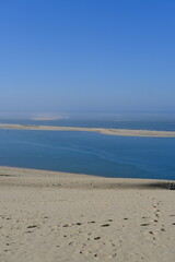 Obraz premium A view from the top of the Pilat dune with a breathtaking view of the Arguin sandbank. La Teste-de-Buch, France - January 25, 2024.