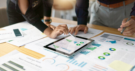 Business people, data analysis with tablet and paperwork, hands with online review in meeting and...