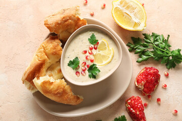 Bowl of tasty baba ghanoush on beige background